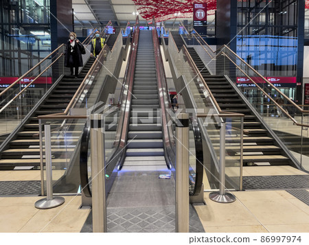 Berlin Brandenburg Airport Willy Brandt main hall. A large, red carpet made of metal mesh flutters through the air of the check-in hall, Magic Carpet by Pae White Berlin Brandenburg Airport Willy Brandt main hall. A large, red carpet made of metal mesh flutters through the air of the check-in hall, Magic Carpet by Pae White 86997974