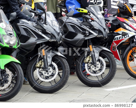 SELANGOR, MALAYSIA - MARCH 4, 2021: Motorcycle tires made from quality rubber. The tires selected must be in accordance with the specifications recommended by the manufacturer. SELANGOR, MALAYSIA - MARCH 4, 2021: Motorcycle tires made from quality rubber. The tires selected must be in accordance with the specifications recommended by the manufacturer. 86998127
