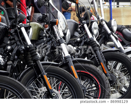 SELANGOR, MALAYSIA - MARCH 4, 2021: Motorcycle tires made from quality rubber. The tires selected must be in accordance with the specifications recommended by the manufacturer. SELANGOR, MALAYSIA - MARCH 4, 2021: Motorcycle tires made from quality rubber. The tires selected must be in accordance with the specifications recommended by the manufacturer. 86998129