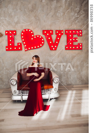 Charming pregnant woman in marsala dress posing on Charming pregnant woman in marsala dress posing on 86998358