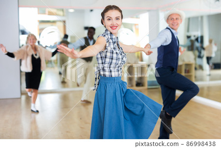 Woman and man dancing swing in studio Woman and man dancing swing in studio 86998438