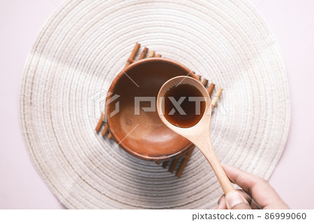 soy sauce on a spoon on table top view  86999060