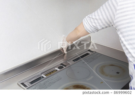 Housewife woman cleaning around the kitchen 86999602