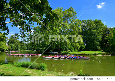 A rental boat floating on Lake Domenil in the forest of Vincennes, Paris, France, taken on August 13, 2021. A rental boat floating on Lake Domenil in the forest of Vincennes, Paris, France, taken on August 13, 2021. 86999692
