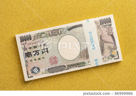 A wad of million yen on a golden background A wad of million yen on a golden background 86999966