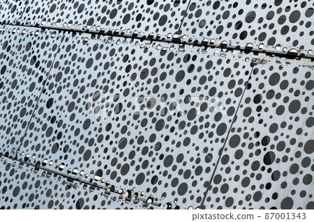 White metal wall with round holes pattern White metal wall with round holes pattern 87001343