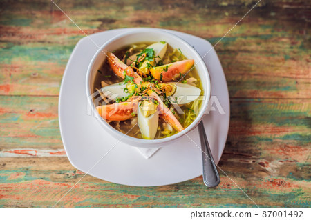 Soto is a traditional Indonesian soup mainly composed of broth, chicken and vegetables 87001492