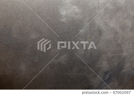 Uncoated flat cold rolled steel sheet surface with minor scratches. Close-up in directly above composition. Uncoated flat cold rolled steel sheet surface with minor scratches. Close-up in directly above composition. 87002097