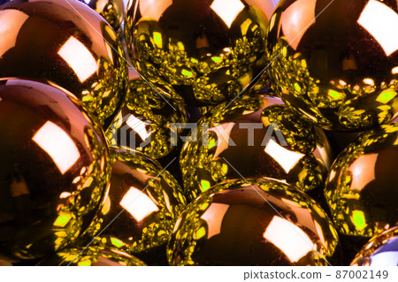 full frame background of golden mirror balls close-up with selective focus 87002149