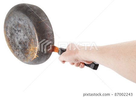 bare caucasian hand holding empty old cast iron frying pan bare caucasian hand holding empty old cast iron frying pan 87002243