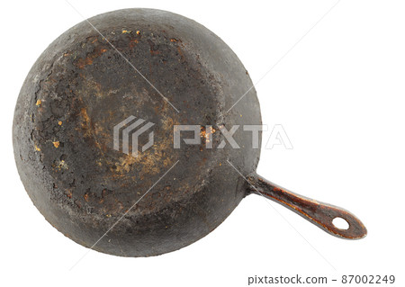 old stained rusty cast iron pan with burnt fat isolated on white bottom up in flat lay perspective old stained rusty cast iron pan with burnt fat isolated on white bottom up in flat lay perspective 87002249