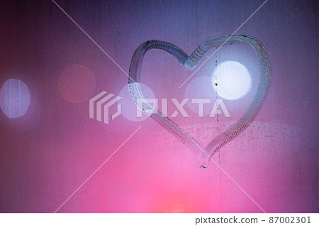 heart symbol hand drawn on wet night window glass in pink colors heart symbol hand drawn on wet night window glass in pink colors 87002301