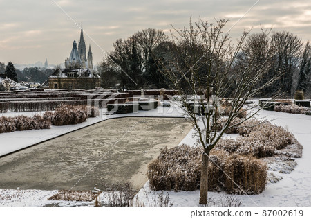 Panoramic view over the Stuyvenberg city park with frozen ponds, snowy reeds and meadows, Laeken, Belgium 87002619