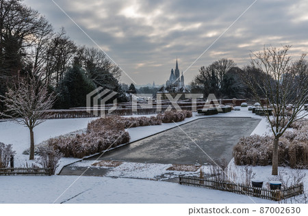 Panoramic view over the Stuyvenberg city park with frozen ponds, snowy reeds and meadows, Laeken, Belgium 87002630