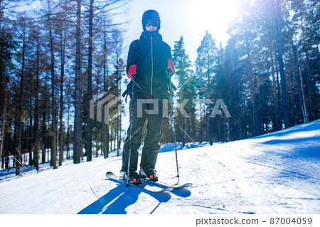 young sweden man in forest ready to drive on ski 87004059