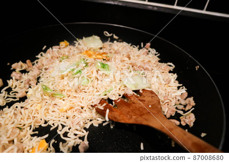 stir fried noodles with pork and vegetable in the pan or cooking food stir fried noodles with pork and vegetable in the pan or cooking food 87008680