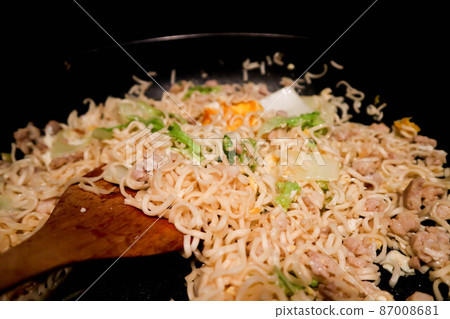 stir fried noodles with pork and vegetable in the pan or cooking food stir fried noodles with pork and vegetable in the pan or cooking food 87008681