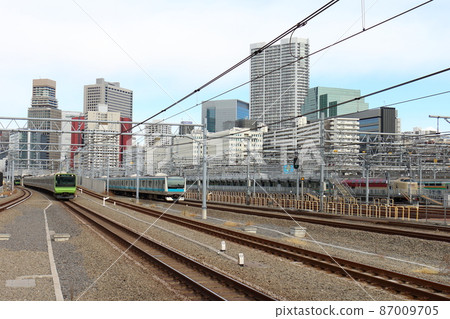 Yamanote Line E235 series train and Keihin Tohoku Line E233 series at Takanawa Gateway Station, sleeper limited express "Sunrise Seto / Izumo" 87009705