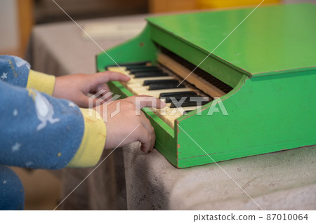 A boy playing a toy piano. A boy playing a toy piano. 87010064