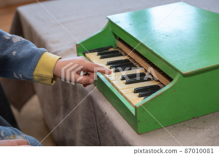 A boy playing a toy piano. A boy playing a toy piano. 87010081