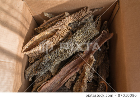 Dried beef offal. Dried tripe. A full cardboard box of chewy dog treats. Dried beef offal. Dried tripe. A full cardboard box of chewy dog treats. 87010086