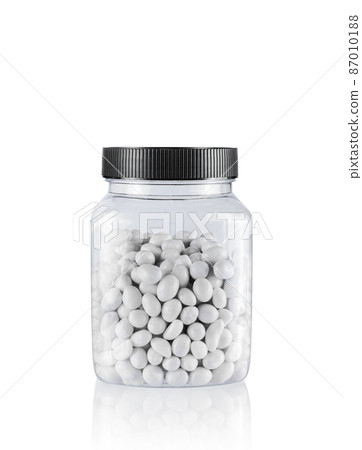 White Candies in Jar on White Background. File With Clipping Path. White Candies in Jar on White Background. File With Clipping Path. 87010188
