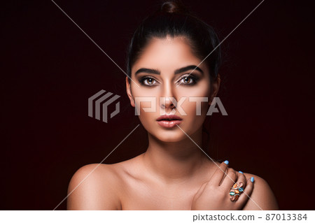 portrait of beautiful asian woman who wears ring while isolated on black background. Jewelry concept 87013384