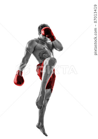 Full size of professional kickboxer in red gloves on white background. Black and white silhouette Full size of professional kickboxer in red gloves on white background. Black and white silhouette 87013419