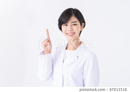 Young woman in white coat with white background 87013516