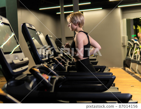 Simulator track workout training lifestyle, from woman healthy in body jogging health, athletic running. Slim health legs, cardio Simulator track workout training lifestyle, from woman healthy in body jogging health, athletic running. Slim health legs, cardio 87014156