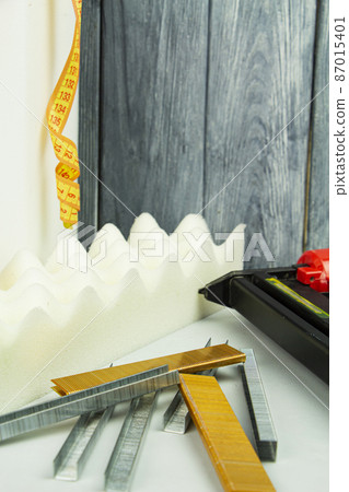 concept of furniture production and repair. Stapler and staples, working tool 87015401