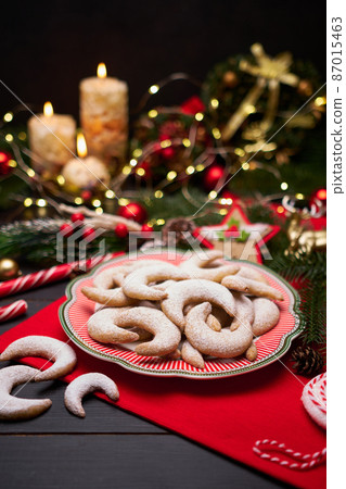 Traditional German or Austrian Vanillekipferl vanilla kipferl cookies on decorated ceramic plate 87015463