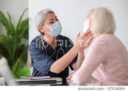 Elderly woman visited by home care specialist Elderly woman visited by home care specialist 87016064