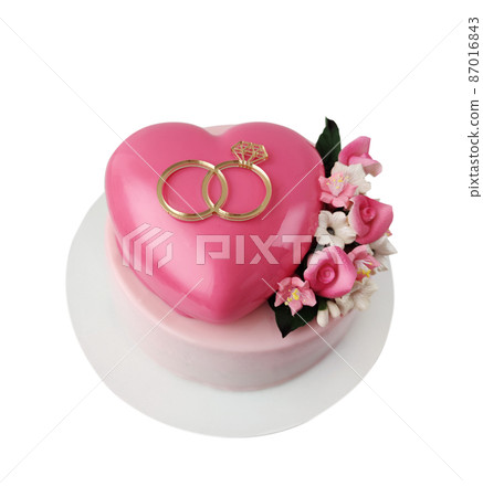 Heart shaped pink icing cake with flowers Heart shaped pink icing cake with flowers 87016843