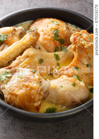 shkmeruli chkmeruli georgian cuisine chicken in a milk garlic sauce closeup in the plate. Vertical shkmeruli chkmeruli georgian cuisine chicken in a milk garlic sauce closeup in the plate. Vertical 87019278