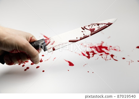 Blood stained knife against white isolated background Blood stained knife against white isolated background 87019540