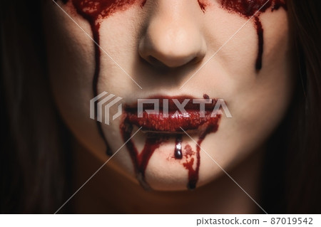 Woman with bloody mouth closeup photo 87019542