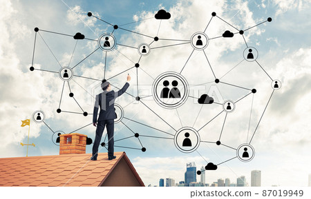 Businessman on house roof presenting networking and connection c Businessman on house roof presenting networking and connection c 87019949
