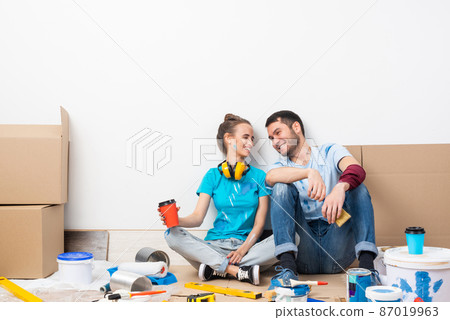 Happy smiling couple relaxing on floor 87019963