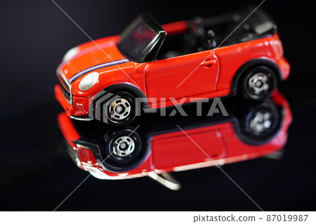 Indoor shooting of a miniature car floating in the mirror Indoor shooting of a miniature car floating in the mirror 87019987