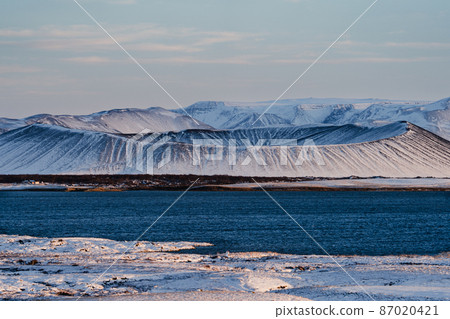 Volcano crater over the lake covered by snow Volcano crater over the lake covered by snow 87020421