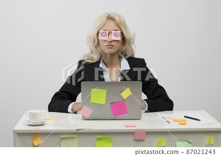 A lot of work concept. Tired young businesswoman having sleeping with stickers on eyes, sitting at workplace A lot of work concept. Tired young businesswoman having sleeping with stickers on eyes, sitting at workplace 87021243