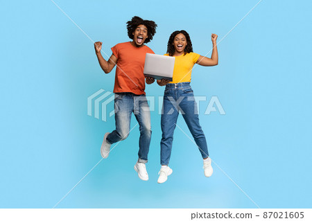Happy african american couple trading online, using computer 87021605