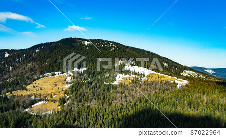 Spruce and evergreen forests of the Carpathians in the morning sun, picturesque landscapes from a bird's eye view. 87022964