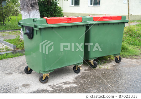 Big green recycling containers on the street 87023315