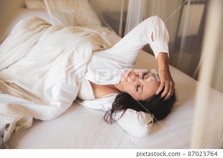 beautiful woman sleeping in white bed in the morning. 87023764