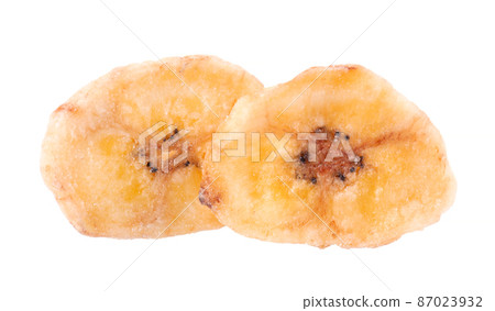 Banana chips isolated on white background. Dried fruit snack. Banana chips isolated on white background. Dried fruit snack. 87023932