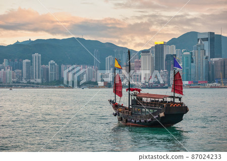 Hong Kong city skyline at Victoria Bay with junk boat and skyscraper business district Hong Kong city skyline at Victoria Bay with junk boat and skyscraper business district 87024233