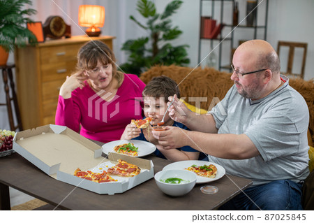 There is one last slice of pizza left and everyone wants to eat it. There is one last slice of pizza left and everyone wants to eat it. 87025845