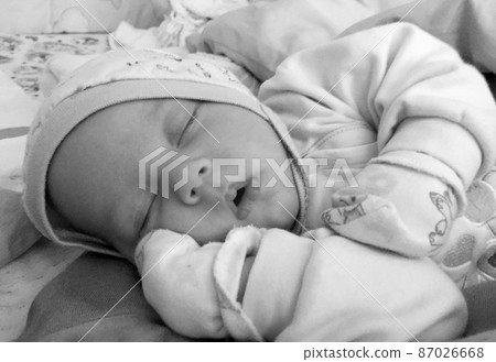 Beautiful sleeping baby boy with child hat posing photographer Beautiful sleeping baby boy with child hat posing photographer 87026668